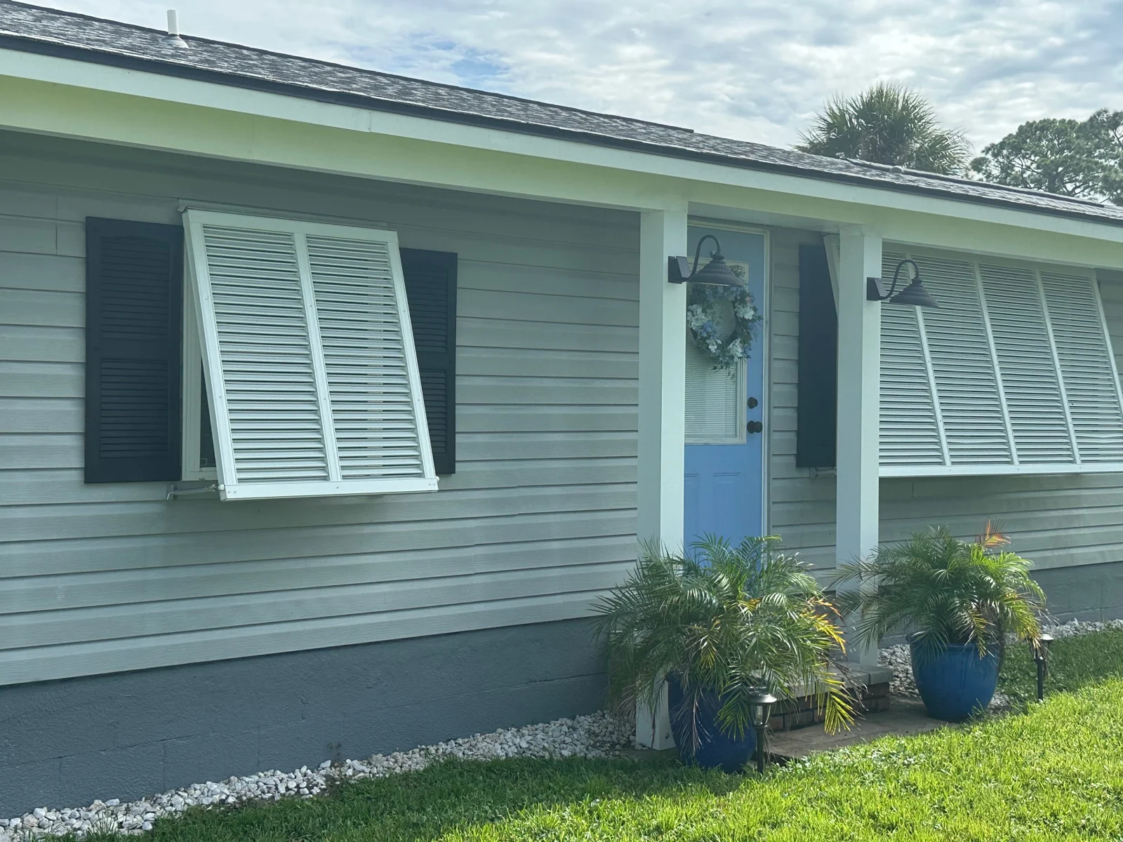 RFH residential exterior project with gray siding and blue shutters