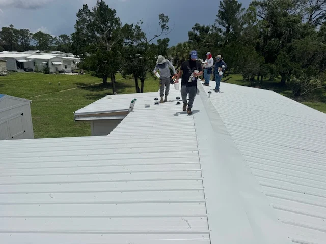 RFH project photo of workers on a manufactured-home roof